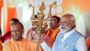 IMAGE: Prime Minister Narendra Modi and Uttar Pradesh Chief Minister Yogi Adityanath hold a trident during a public meeting in support of Bharatiya Janata Party (BJP) candidate from Barabanki constituency Rajrani Rawat for the Lok Sabha polls, in Barabanki on Friday, May 17, 2024. Photograph: ANI Photo